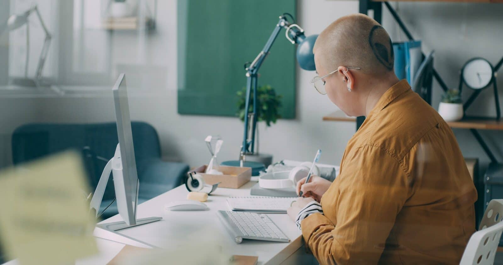 A man sitting at a desk working on a computer